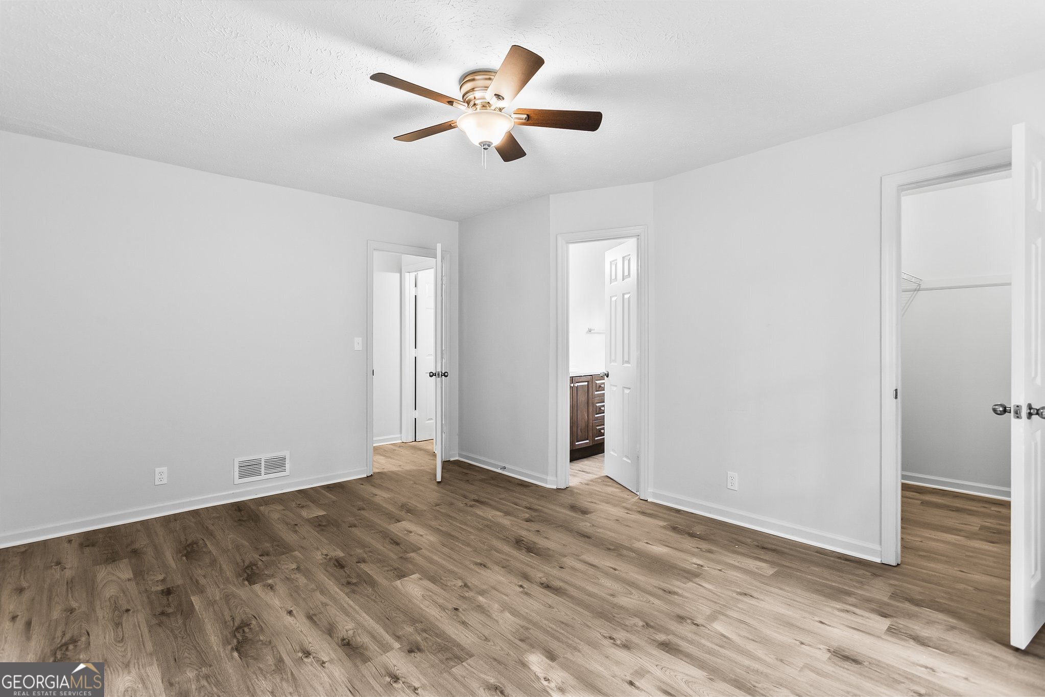 3620 Knoll Crest Trail Buford, GA 30519 - Photo 21 of 47 an empty room with wooden floor and ceiling fan