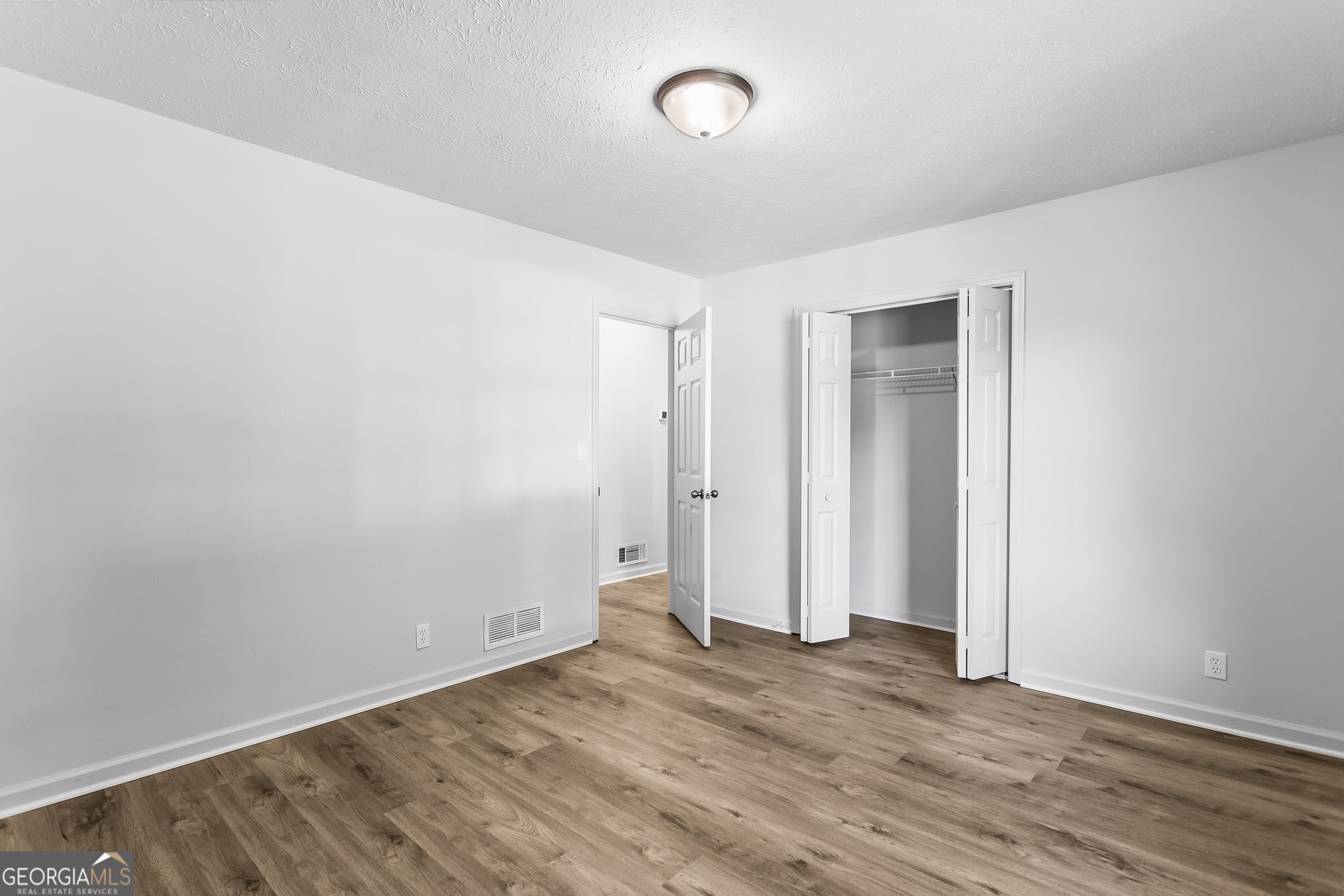 3620 Knoll Crest Trail Buford, GA 30519 - Photo 23 of 47 an empty room with wooden floor and windows