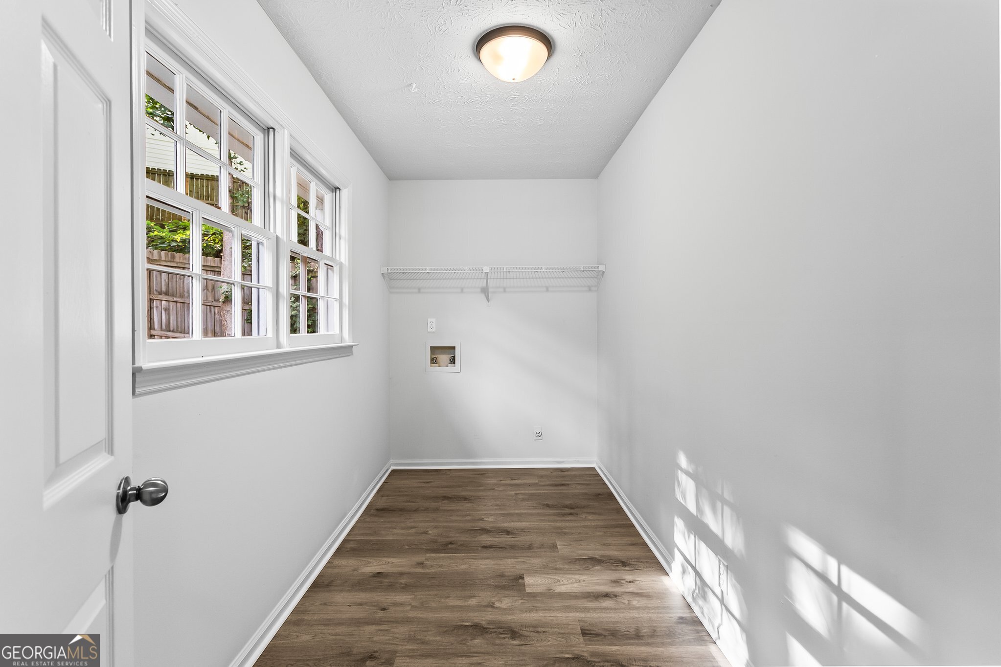 3620 Knoll Crest Trail Buford, GA 30519 - Photo 3 of 47 a view of a hallway with wooden floor and a window
