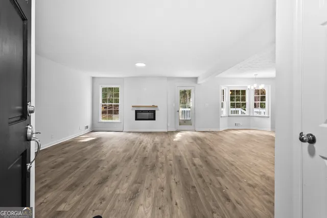 an empty room with windows and natural light