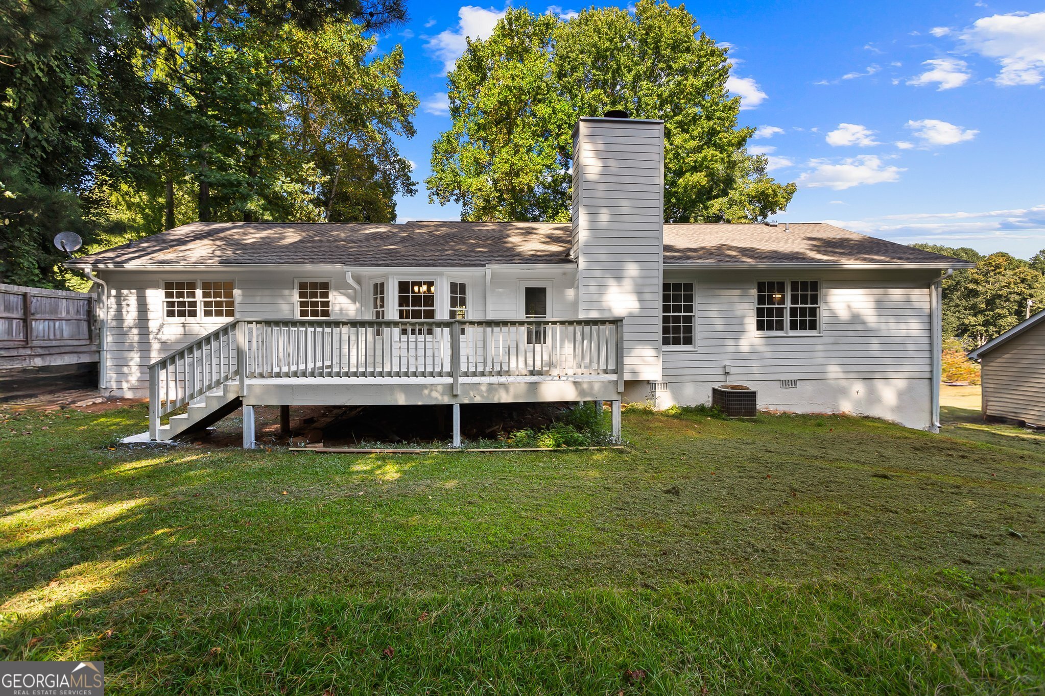 3620 Knoll Crest Trail Buford, GA 30519 - Photo 43 of 47 a view of a house with a wooden deck and a yard