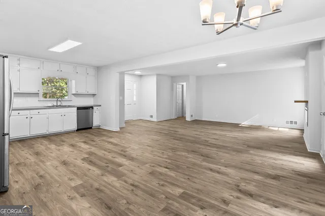 a big room with wooden floor and cabinet