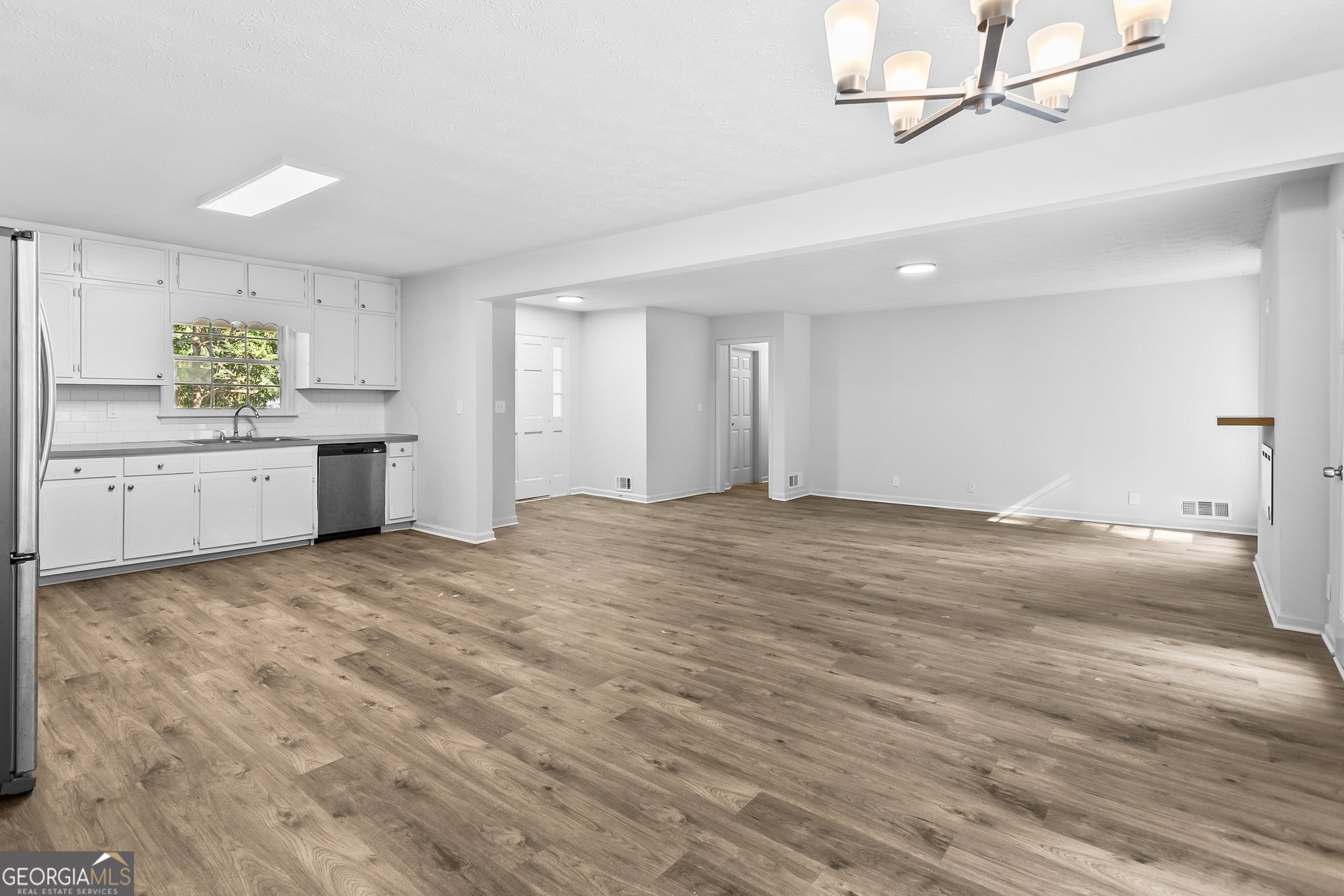 3620 Knoll Crest Trail Buford, GA 30519 - Photo 10 of 47 a big room with wooden floor and cabinet