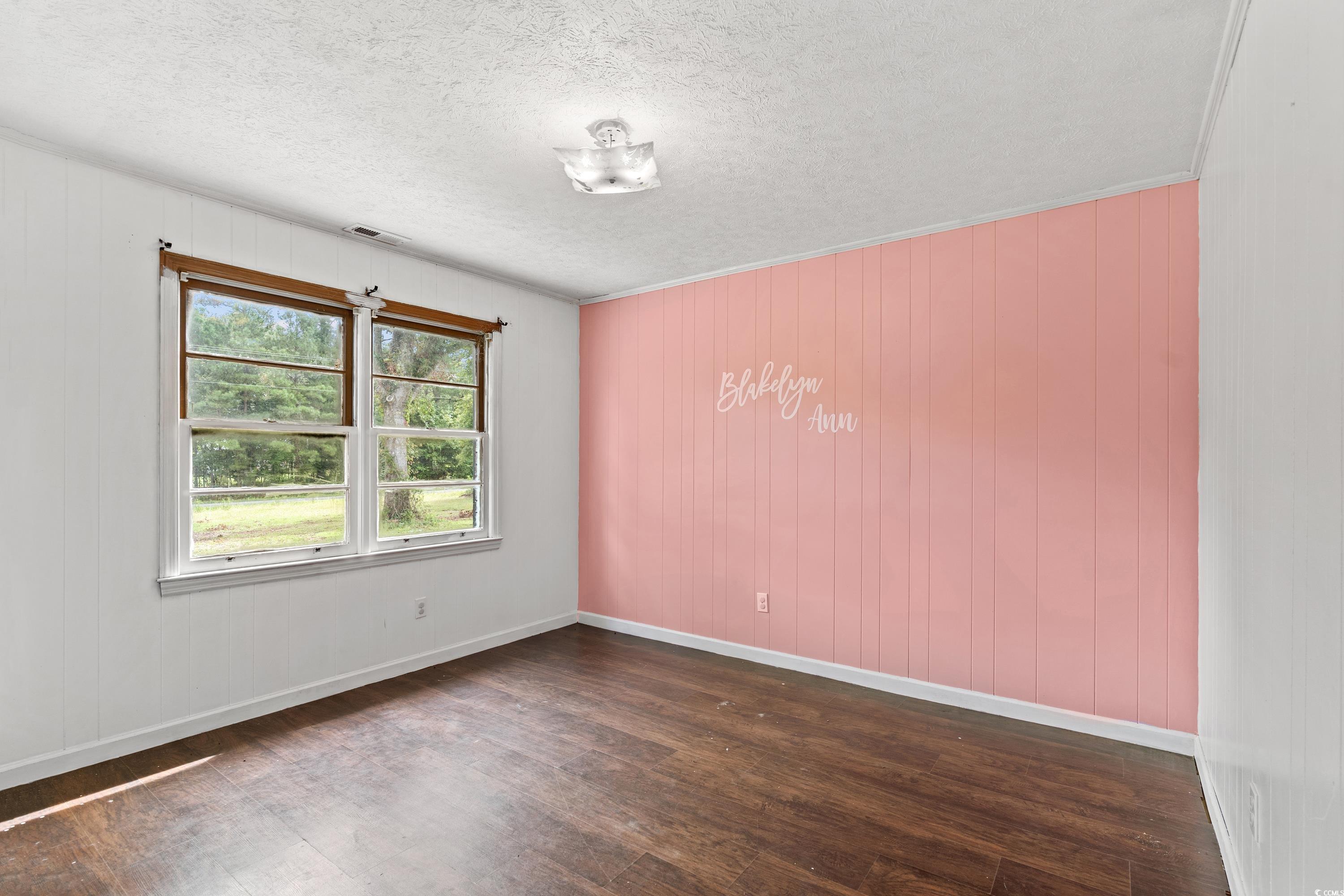 476 Live Oak Church Road Loris, SC 29569 - Photo 16 of 39 Empty room with a textured ceiling, ornamental mol