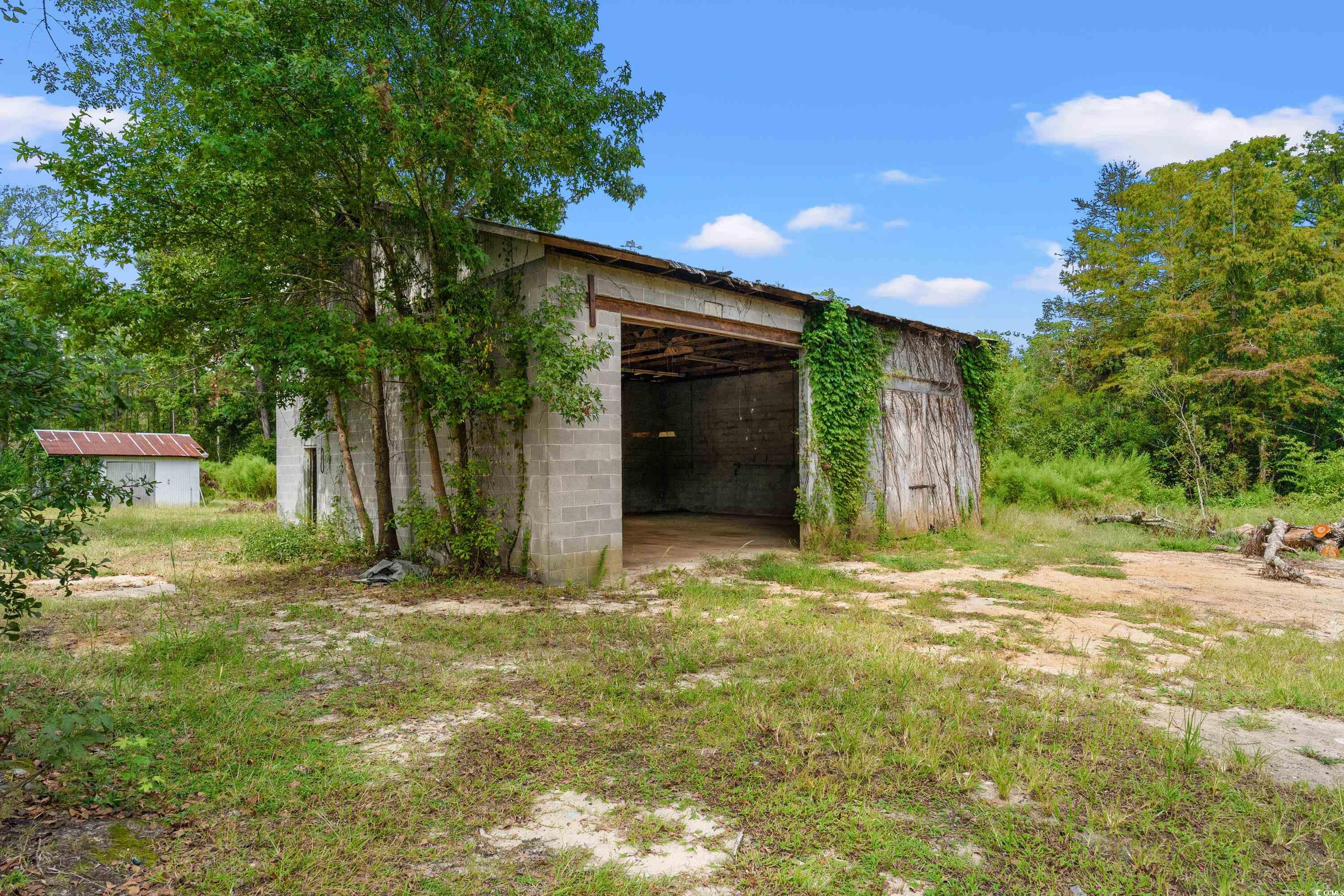 476 Live Oak Church Road Loris, SC 29569 - Photo 20 of 39 View of yard featuring a shed