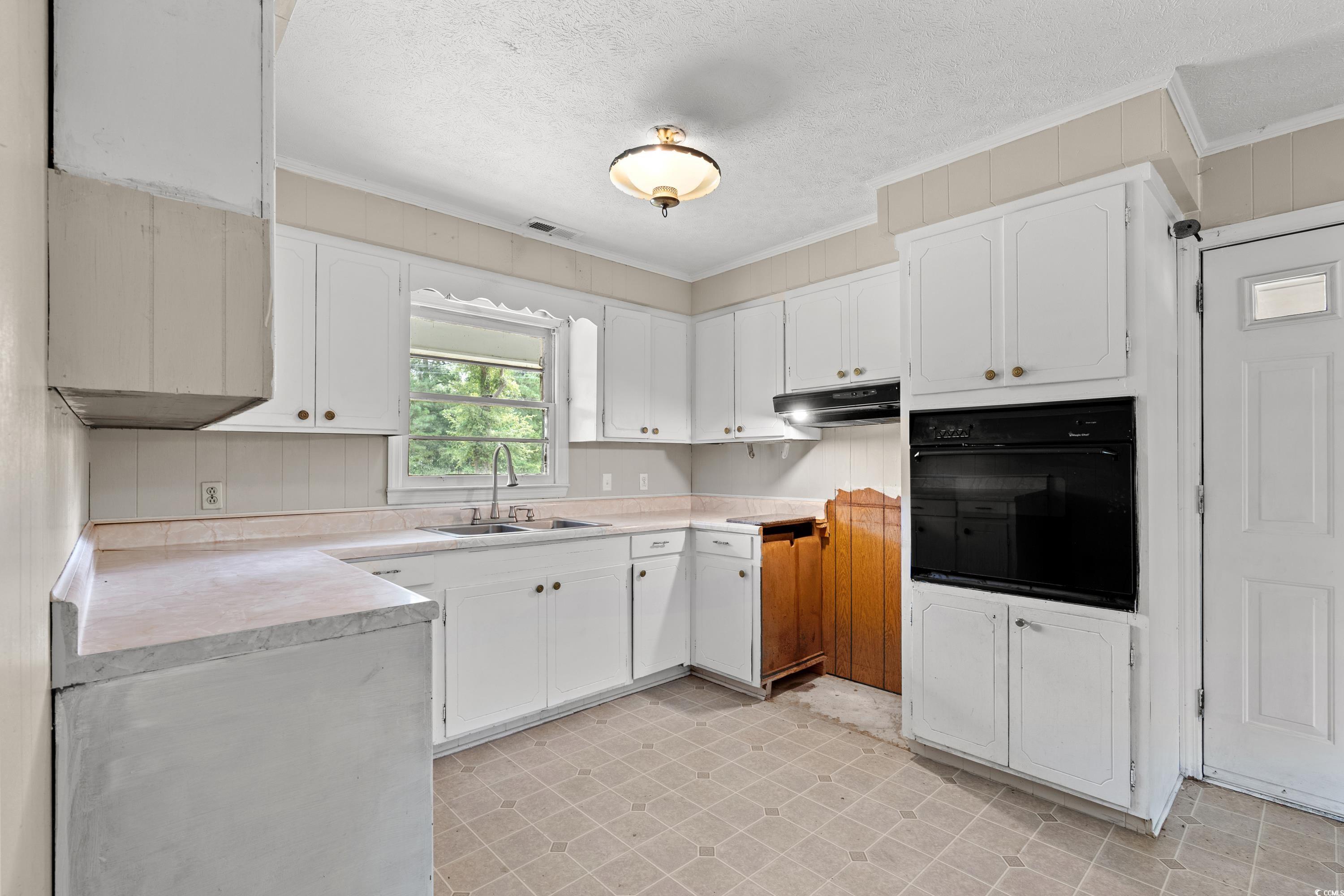 476 Live Oak Church Road Loris, SC 29569 - Photo 5 of 39 Kitchen with crown molding, a textured ceiling, si