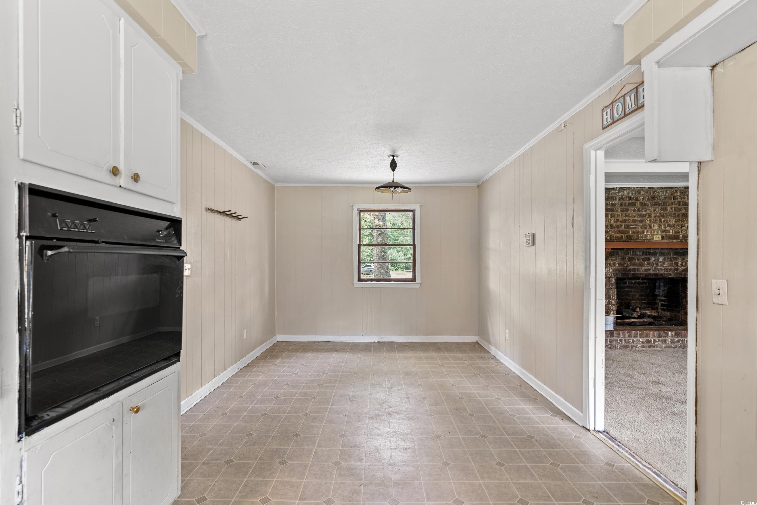476 Live Oak Church Road Loris, SC 29569 - Photo 6 of 39 Kitchen with ornamental molding, white cabinetry,