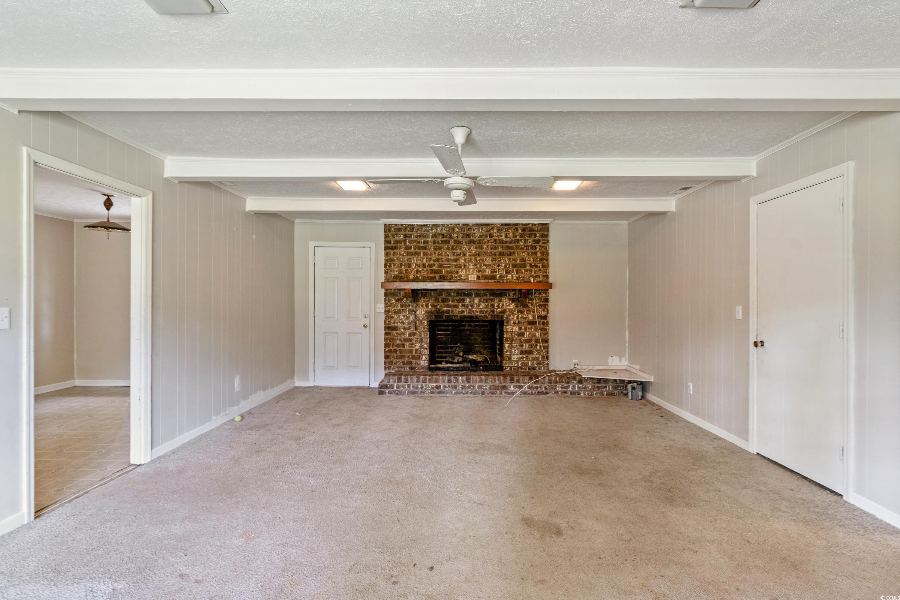 476 Live Oak Church Road Loris, SC 29569 - Photo 7 of 39 Unfurnished living room with carpet, ceiling fan,