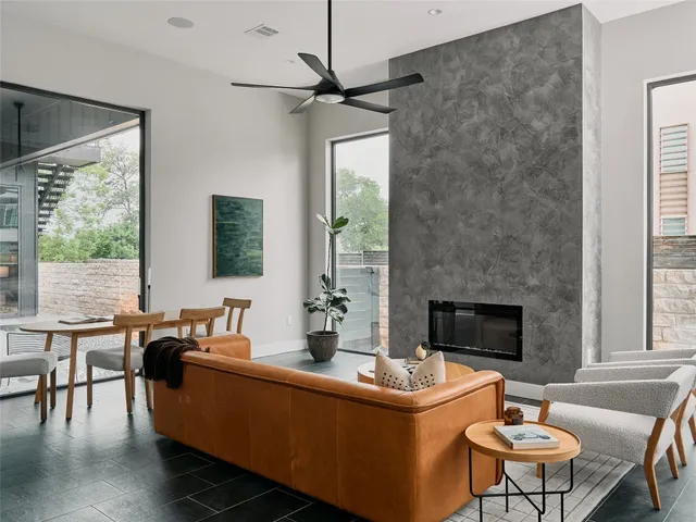 a living room with furniture and a wooden floor