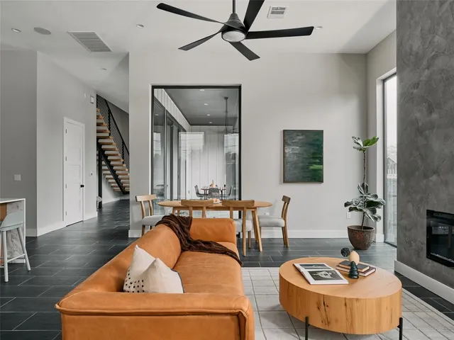 a kitchen with stainless steel appliances a table chairs window and cabinets