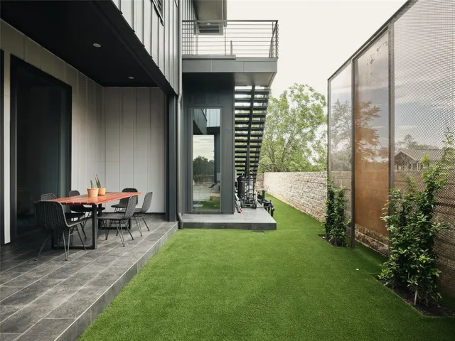 a living room with couches and a view of kitchen