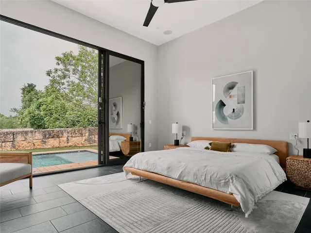 a bedroom with a bed and a large window