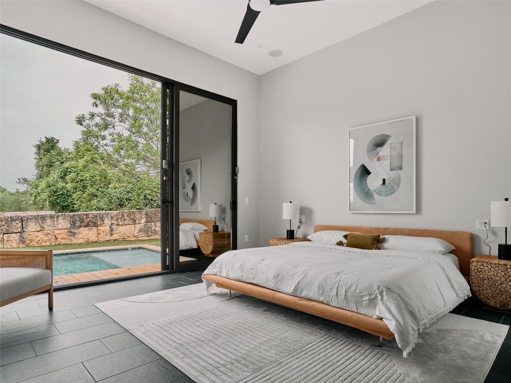 412 Kemp Street Austin, TX 78741 - Photo 17 of 37 Bedroom featuring access to exterior and ceiling fan
