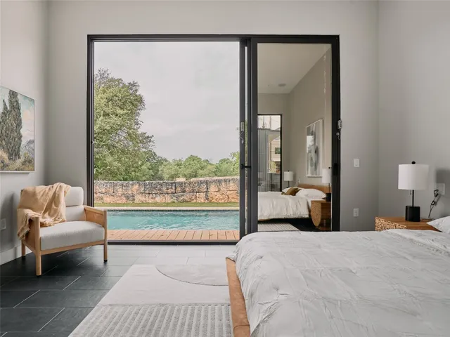 a bedroom with a large bed and a window