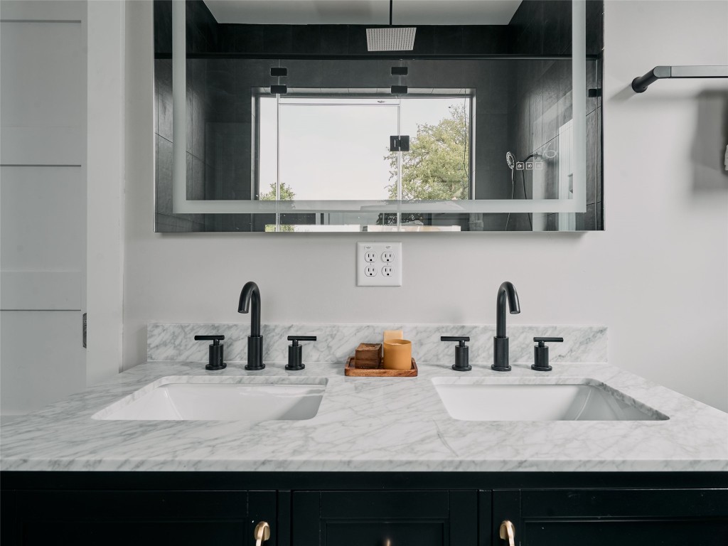 412 Kemp Street Austin, TX 78741 - Photo 21 of 37 Full bath featuring double vanity and a shower