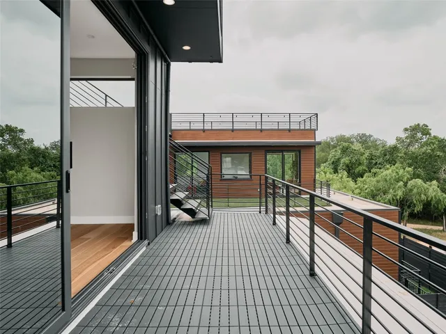 a bathroom with a toilet sink vanity granite and shower