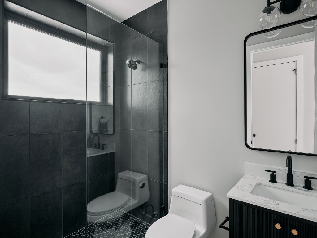 412 Kemp Street Austin, TX 78741 - Photo 26 of 37 Full bath with vanity and a walk in shower