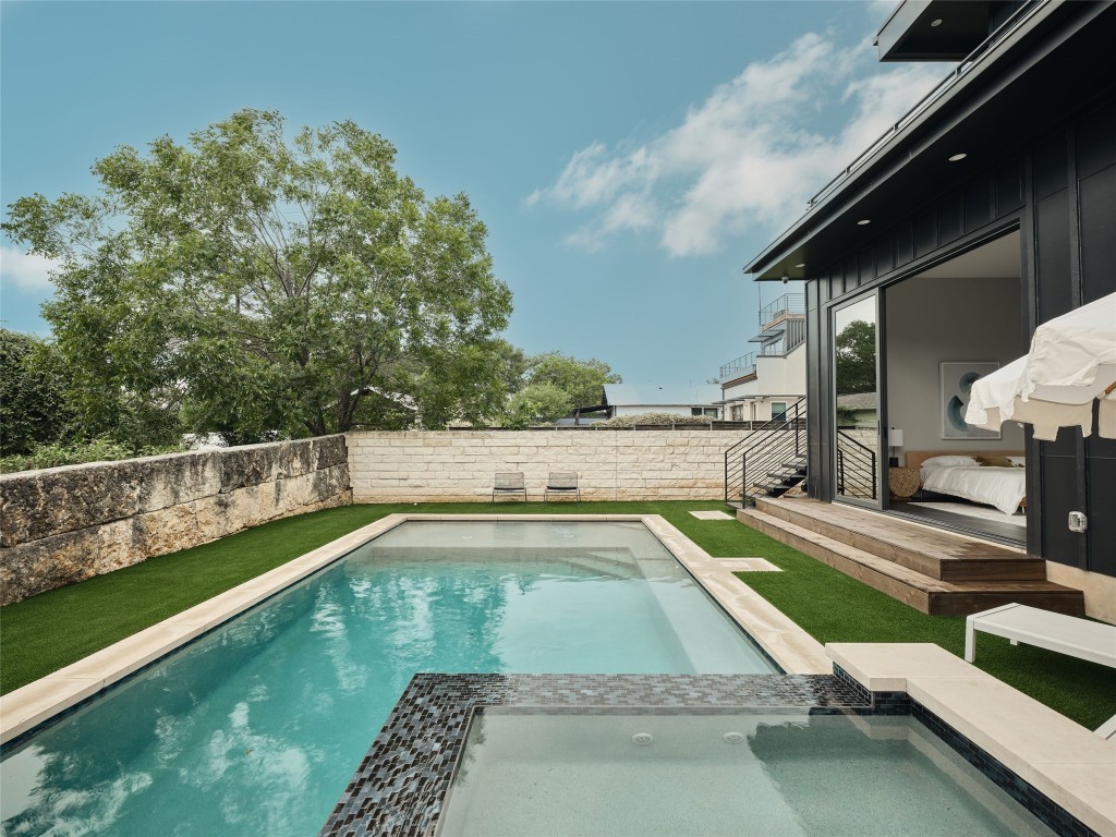412 Kemp Street Austin, TX 78741 - Photo 32 of 37 View of swimming pool with a patio area, a fenced backyard, and a pool with connected hot tub