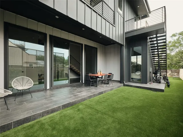 an aerial view of multiple houses with yard