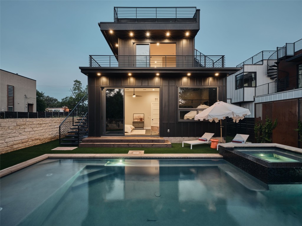 412 Kemp Street Austin, TX 78741 - Photo 8 of 37 Back of property with a patio, stairs, a pool with connected hot tub, and a balcony