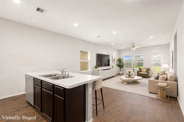 a living room with furniture a flat screen tv and a table