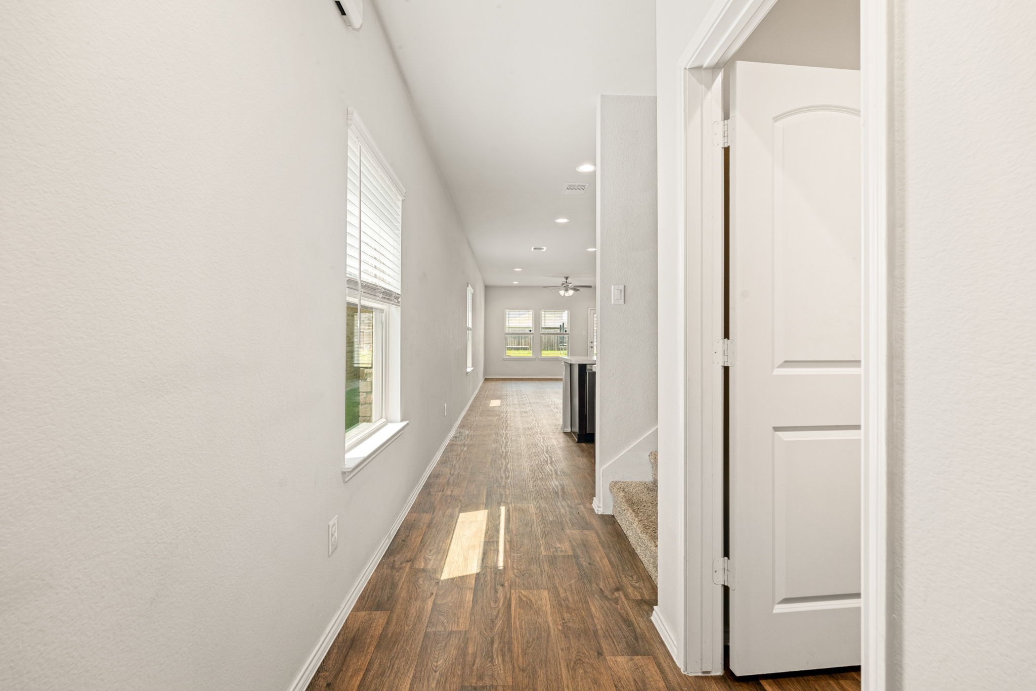 23119 Rivercane Shadow Trail Spring, TX 77373 - Photo 11 of 29 a view of a hallway with wooden floor and staircase
