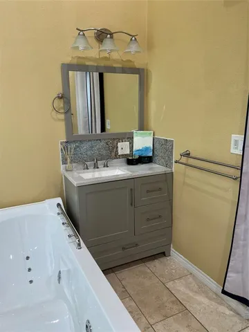 a bath tub sitting in a bathroom next to a window