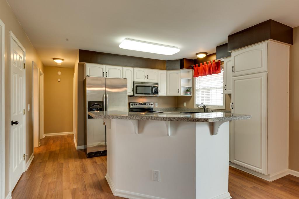 3636 Mahlon Moore Road Spring Hill, TN 37174 - Photo 8 of 22 a kitchen with stainless steel appliances a refrigerator and a stove