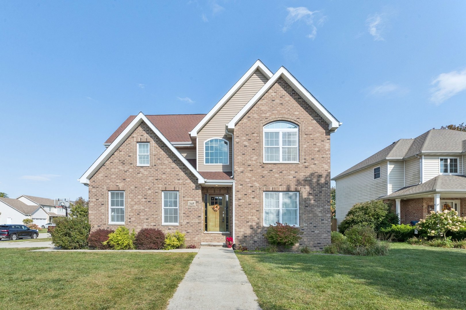 a front view of a house with a garden