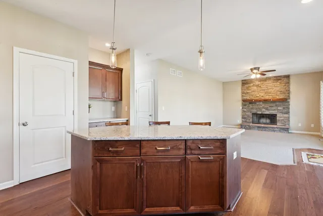a kitchen with stainless steel appliances a sink stove and wooden floor