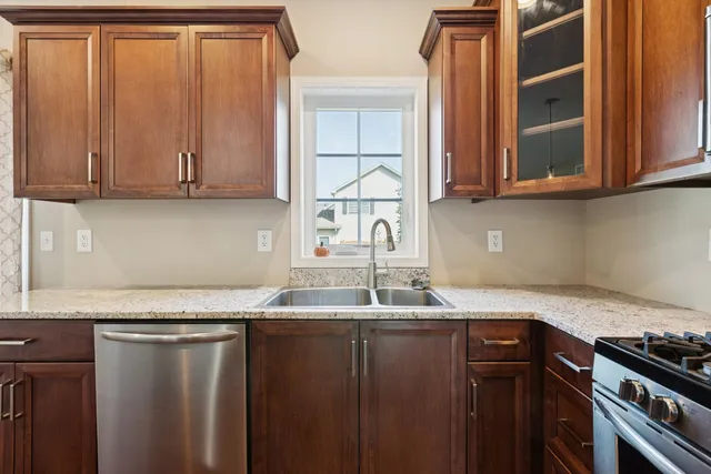 a kitchen with granite countertop cabinets washer and dryer