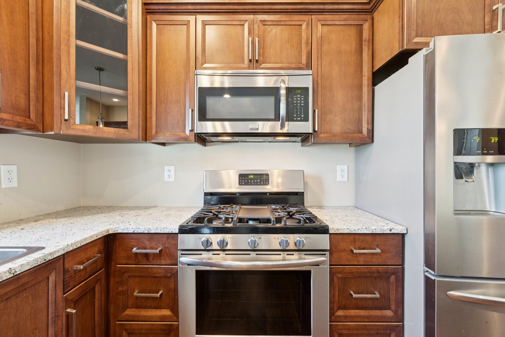 345 South Calkey Street Diamond, IL 60416 - Photo 13 of 50 a kitchen with stainless steel appliances granite countertop a stove and a microwave