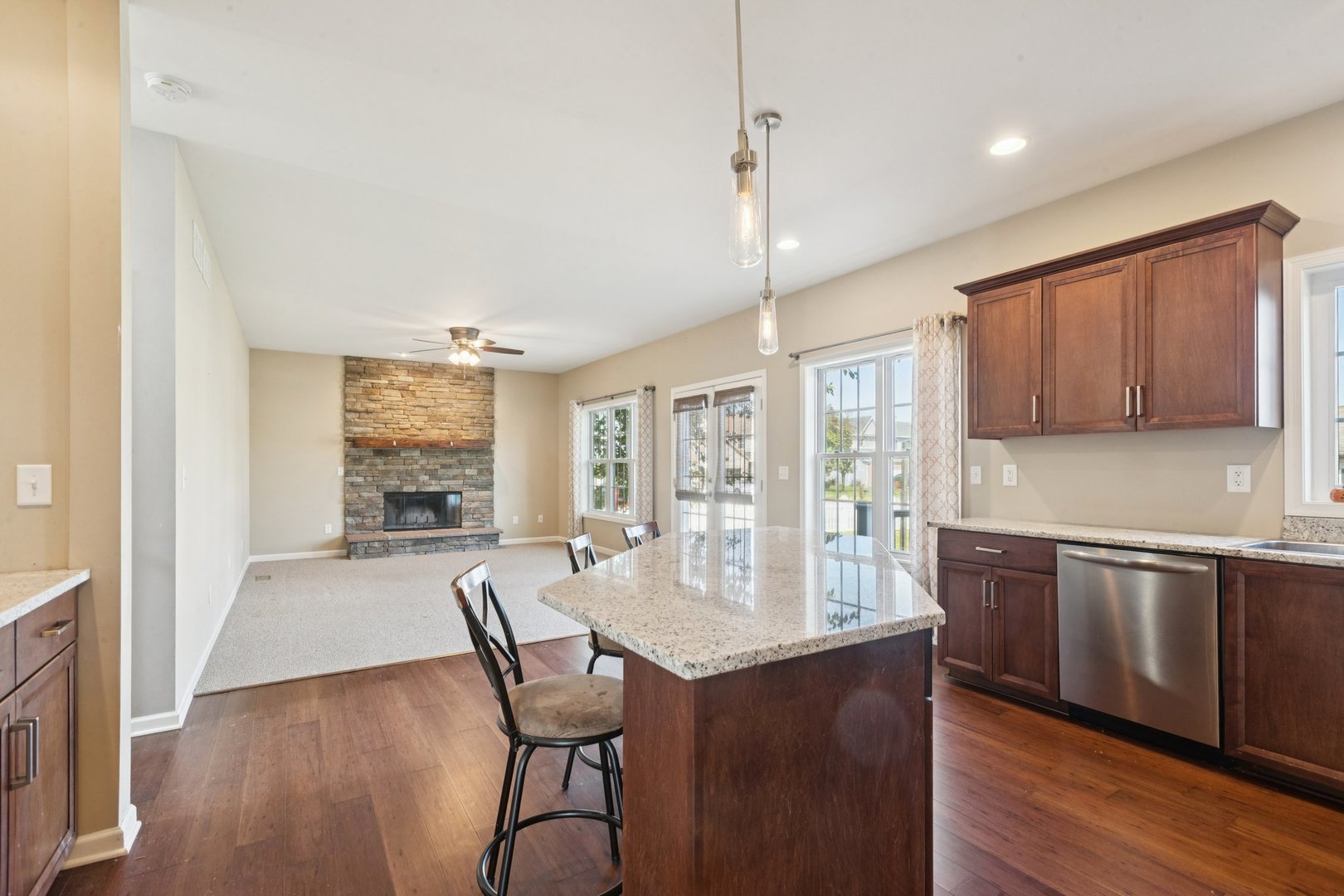 345 South Calkey Street Diamond, IL 60416 - Photo 14 of 50 a open kitchen with granite countertop a stove a sink dishwasher a dining table and chairs with wooden floor