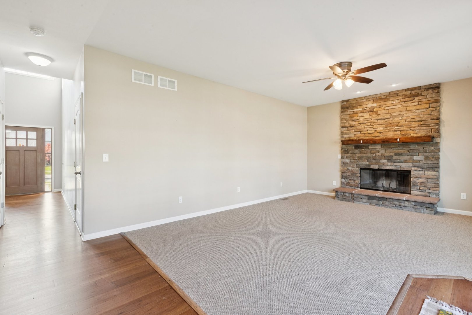 345 South Calkey Street Diamond, IL 60416 - Photo 15 of 50 an empty room with windows fireplace and a kitchen view