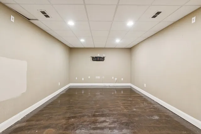 an empty room with a empty space and windows