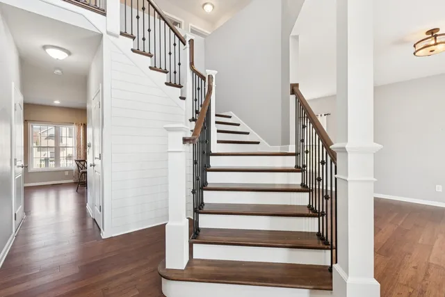 a view of entryway and hall with wooden floor