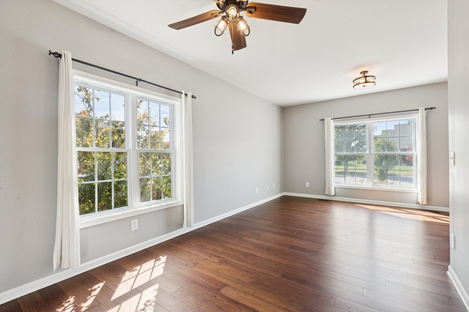 345 South Calkey Street Diamond, IL 60416 - Photo 7 of 50 a view of an empty room with wooden floor and a window