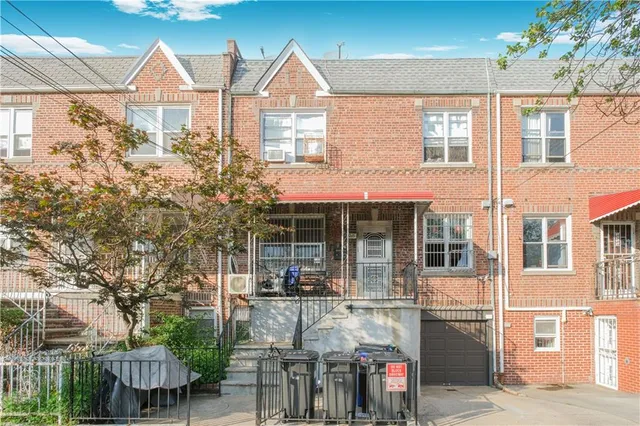 a view of a brick house with large windows and a table
