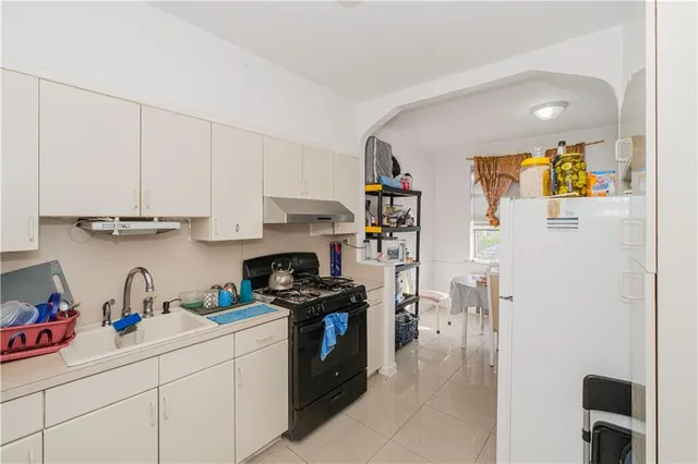 a kitchen with stainless steel appliances granite countertop a refrigerator sink and cabinets