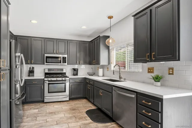 a kitchen with a sink stove and microwave