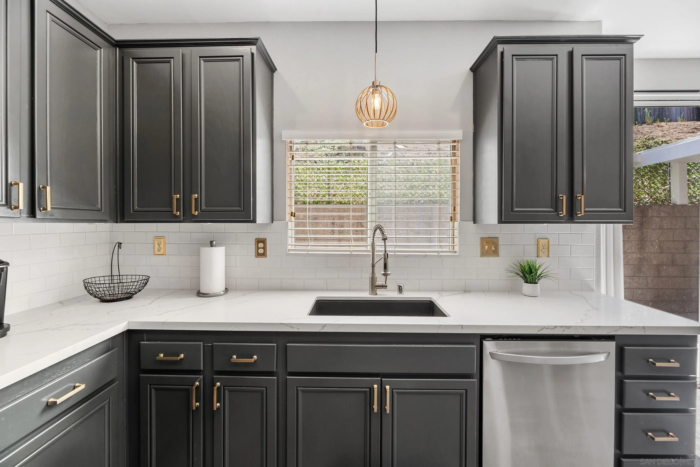 2969 River Dance Way Alpine, CA 91901 - Photo 14 of 40 a kitchen with granite countertop a sink cabinets and window