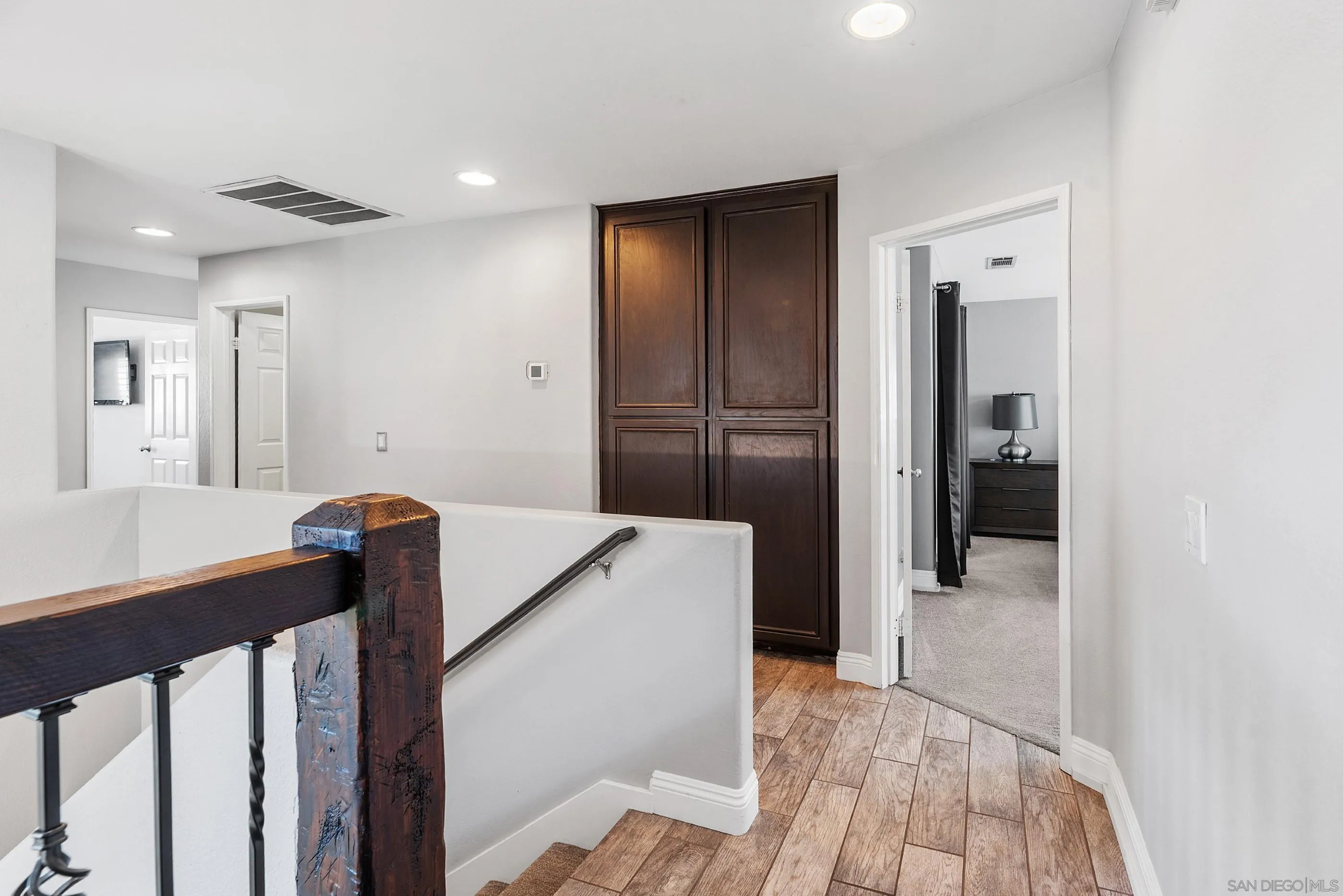 2969 River Dance Way Alpine, CA 91901 - Photo 25 of 40 a view of a hallway with wooden floor and staircase