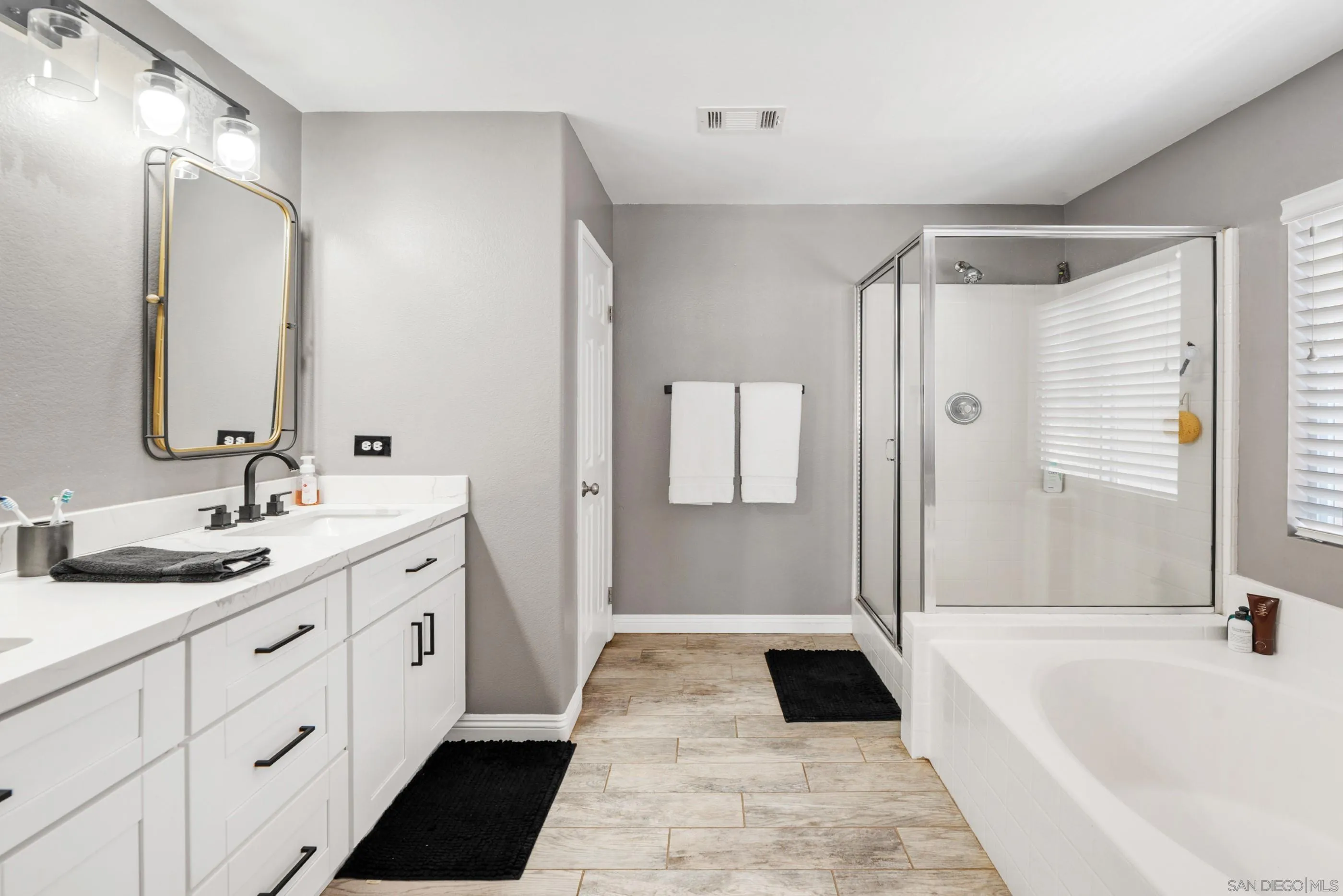 2969 River Dance Way Alpine, CA 91901 - Photo 28 of 40 a bathroom with a tub sink and mirror