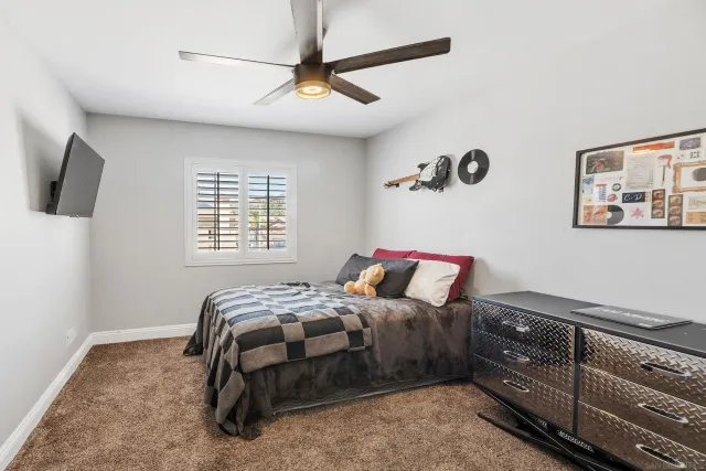 a bedroom with a bed and flat screen tv
