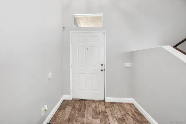 an empty room with wooden floor