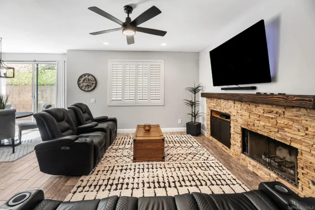 a living room with a flat screen tv and a fireplace