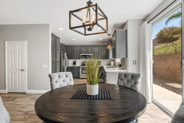 a view of a dining room with furniture a chandelier and wooden floor