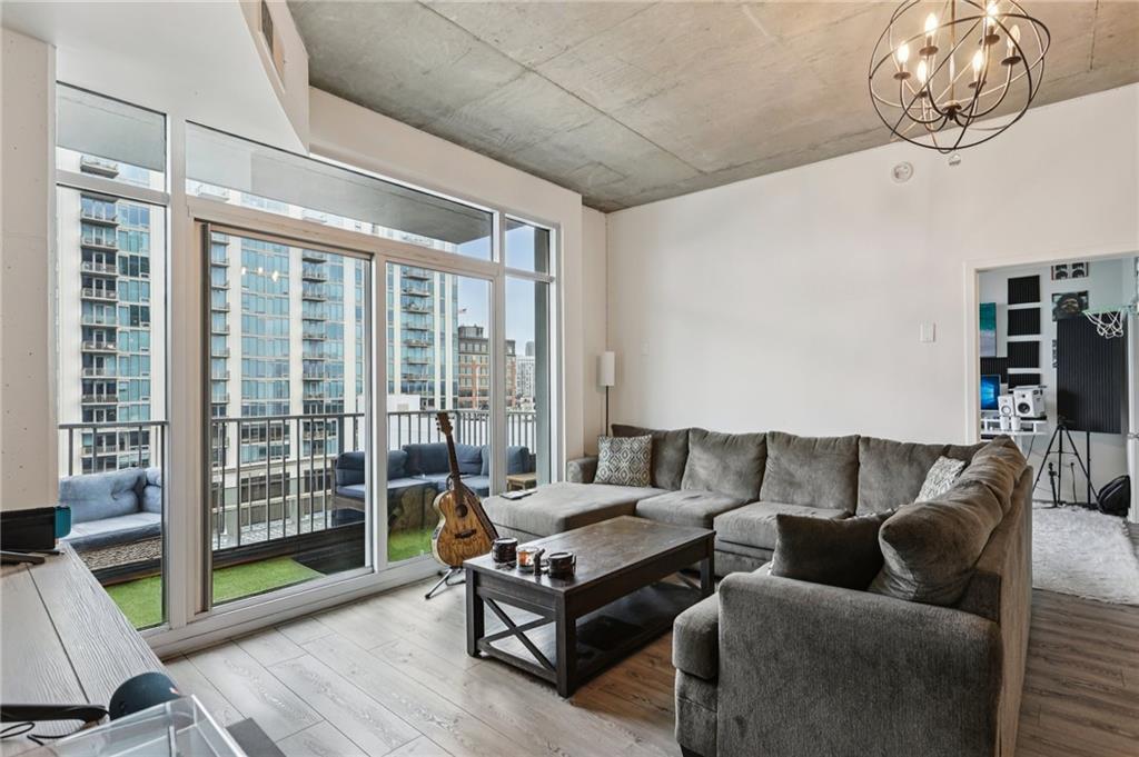a living room with furniture and a floor to ceiling window
