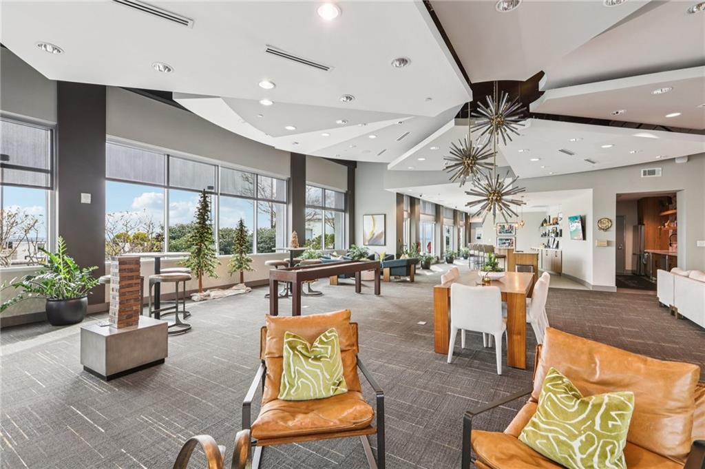 250 Pharr Road Northeast, Unit 1005 Atlanta, GA 30305 - Photo 21 of 25 a living room with furniture and a large window