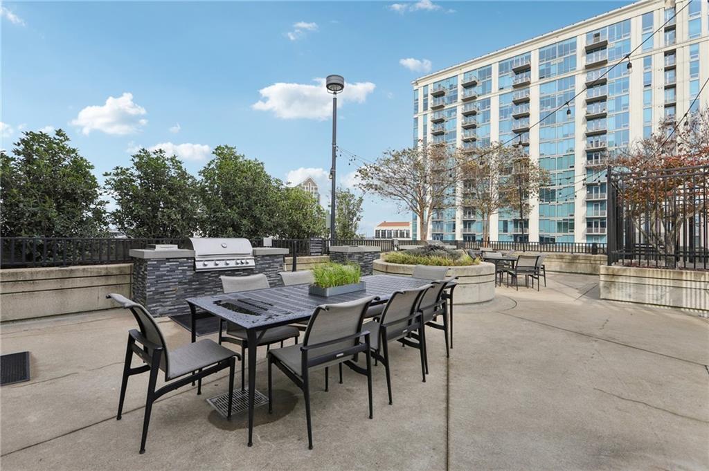 250 Pharr Road Northeast, Unit 1005 Atlanta, GA 30305 - Photo 25 of 25 a view of a dinning tables and chairs in the patio